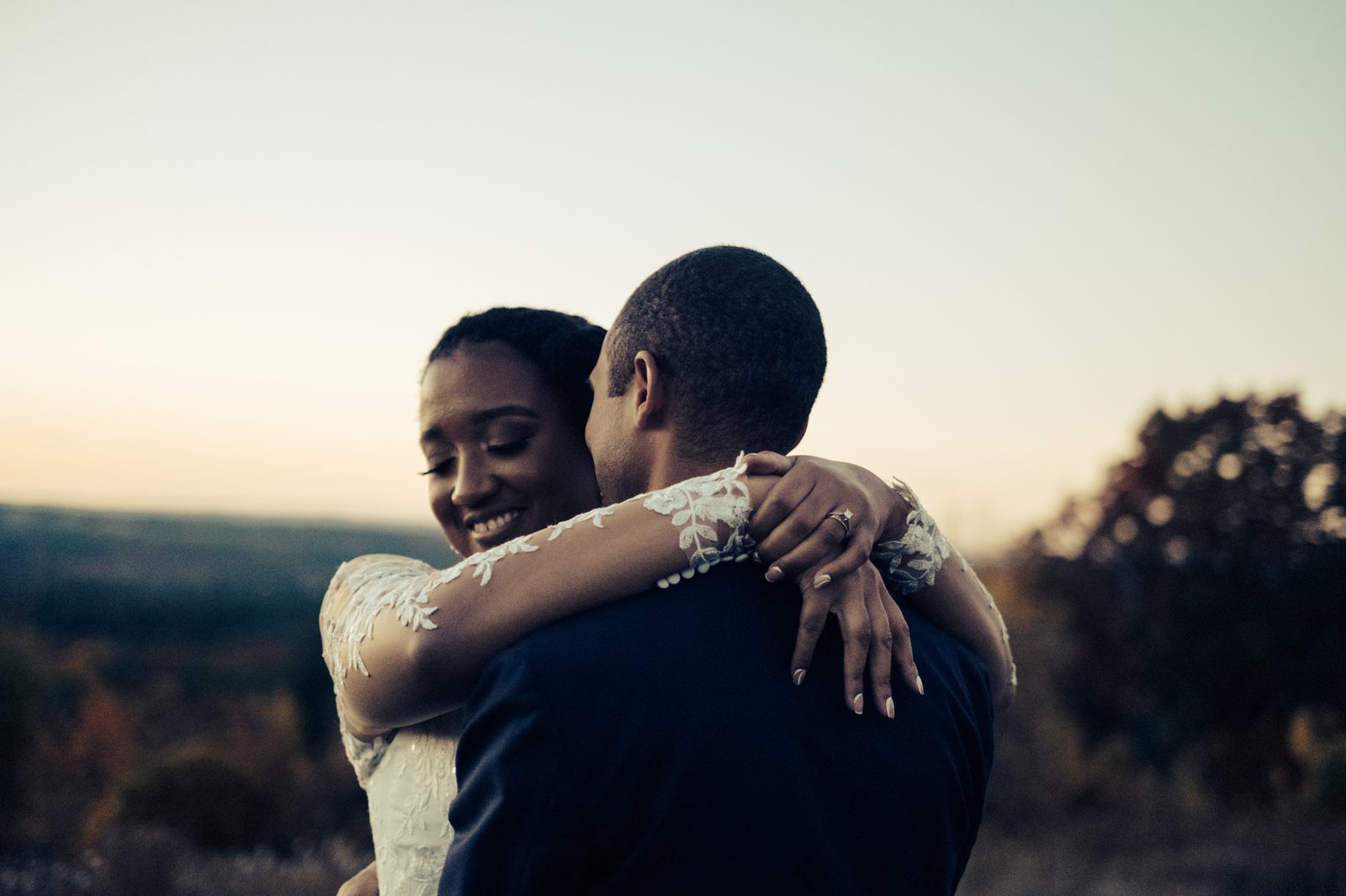 Couple embrace at sunset